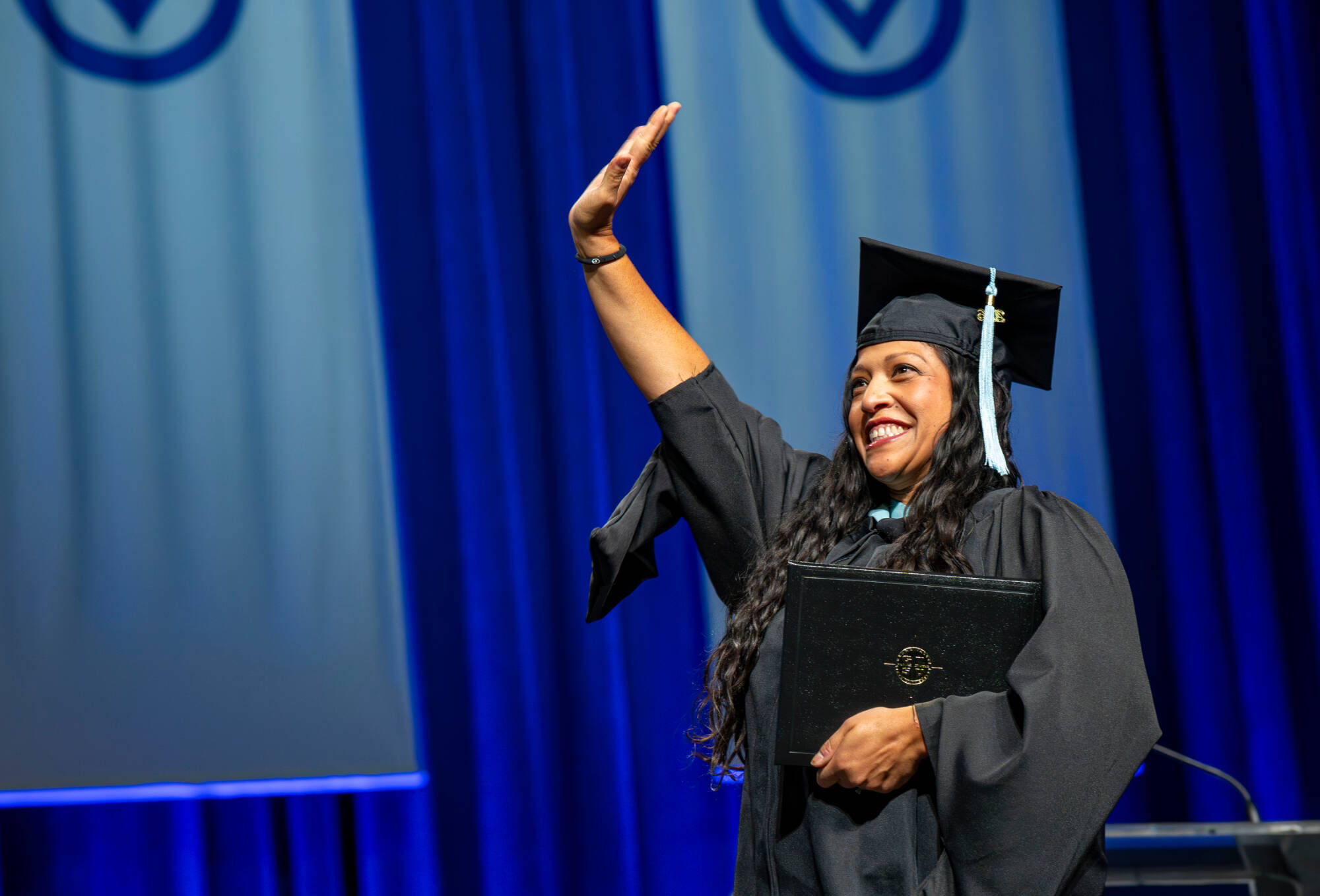 A graduate reacts while walk past the stage after receiving their diploma during the Commencement ceremony at Van Andel Arena on May 1.